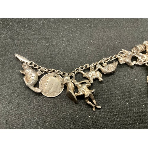 58 - 2 SILVER CHARM BRACELETS (TESTED) WITH A TOTAL OF 25 SILVER & WHITE METAL CHARMS ADDITIONAL CHARM PL... 