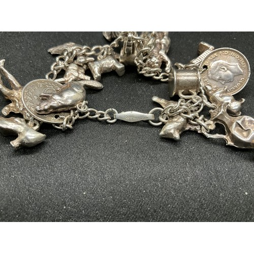 58 - 2 SILVER CHARM BRACELETS (TESTED) WITH A TOTAL OF 25 SILVER & WHITE METAL CHARMS ADDITIONAL CHARM PL... 