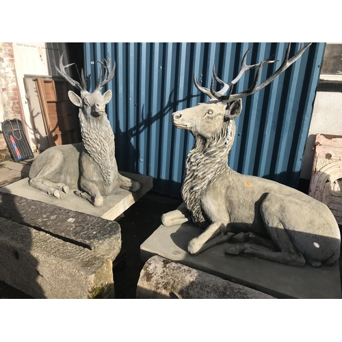 437 - Pair Of Reconstituted Bath Stone Lying Red Stags