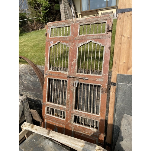 376 - Pair of antique wooden doors with steel bars