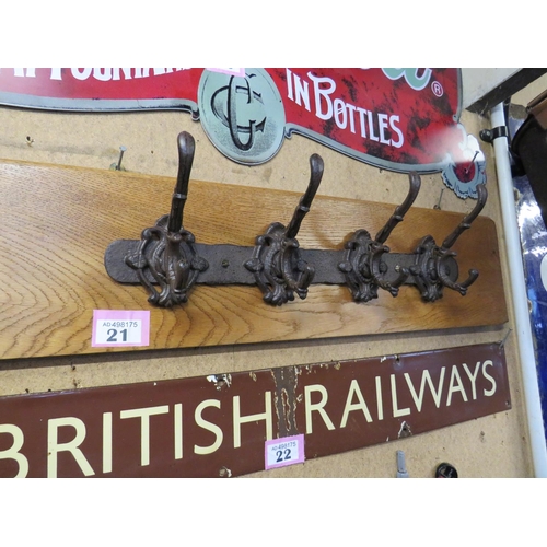 21 - 4 coat hangers on oak plinth