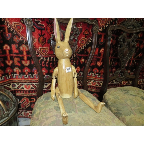 314 - 2 wooden jointed rabbits