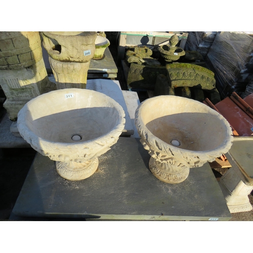 311 - Pair reconstituted stone urns on plinths diameter 21