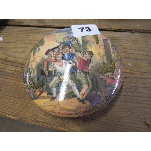 73 - Antique tobacco pot lid titled The wolf & the lamb