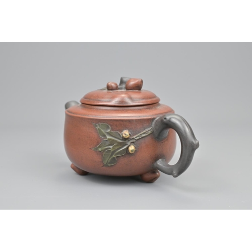 13 - A chinese yixing pottery tea pot. diameter approx. 18cm