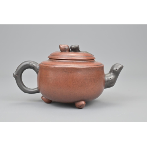 13 - A chinese yixing pottery tea pot. diameter approx. 18cm