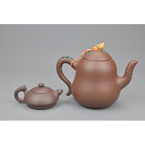 15 - Two chinese yixing tea pots. width approx. 18cm (2)