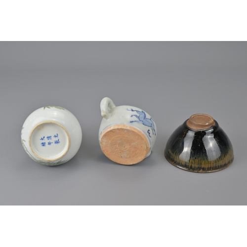 18 - Three chinese small items. together with black tea bowl, blue and white water dropper and vase. vase... 