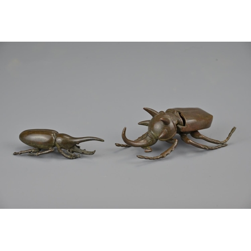 329 - Two japanese late meiji period bronze beetles. larger with opening box cover. each signed underneath... 