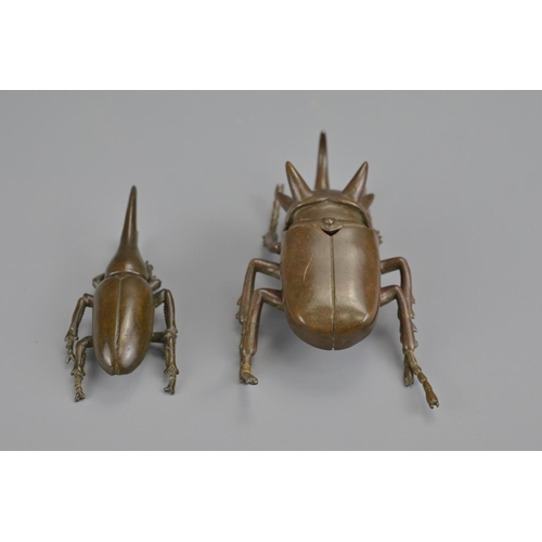 329 - Two japanese late meiji period bronze beetles. larger with opening box cover. each signed underneath... 