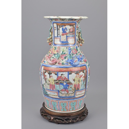 41 - A 19th century chinese cantonese porcelain vase. with a later wooden stand. height approx. 35cm.