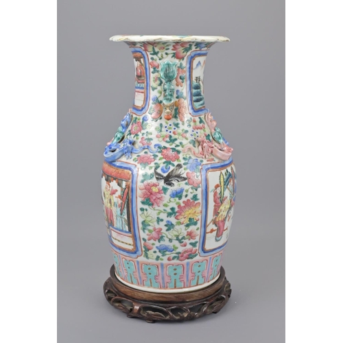 41 - A 19th century chinese cantonese porcelain vase. with a later wooden stand. height approx. 35cm.