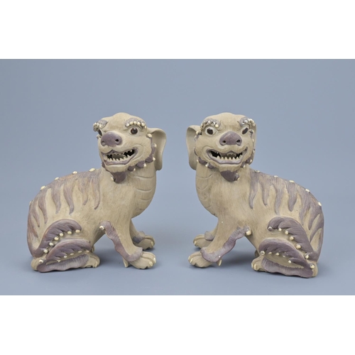 63 - Pair of chinese pottery lions. height approx. 17cm (2)