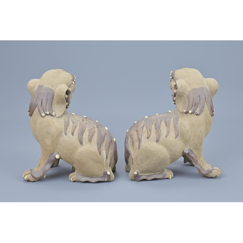 63 - Pair of chinese pottery lions. height approx. 17cm (2)