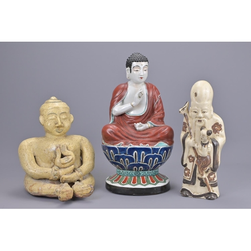 70 - A chinese cizhou ware shulou figure together with a thai seated figure and japanese kutani polychrom... 