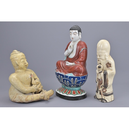 70 - A chinese cizhou ware shulou figure together with a thai seated figure and japanese kutani polychrom... 