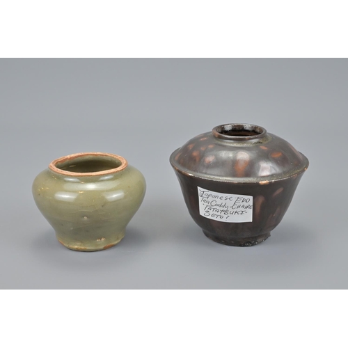 75 - Four chinese song to ming black glazed pots together with a yuan dynasty celadon pot. `teapot height... 