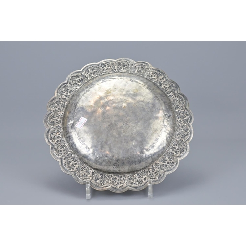 76 - An indian embossed white metal dish. diameter approx. 26cm