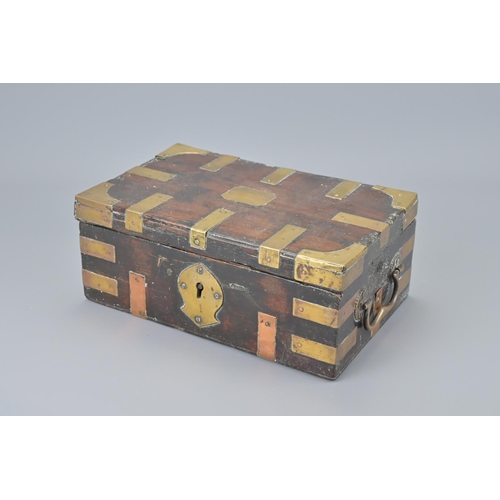 86 - An indian hardwood box with brass mounts and two handles. width approx. 25cm