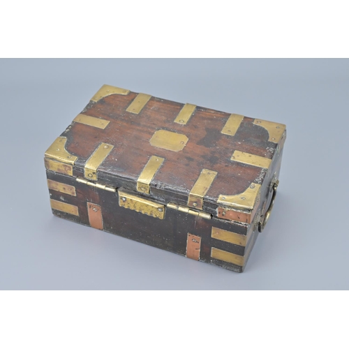 86 - An indian hardwood box with brass mounts and two handles. width approx. 25cm