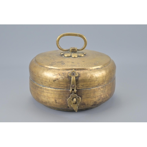 87 - An indian brass hinged box with lion padlock and key. width approx. 23cm