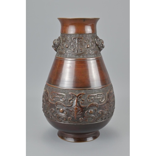 89 - A chinese bronze vase. with twin taotie mask and four character mark of wanli, height approx. 27cm