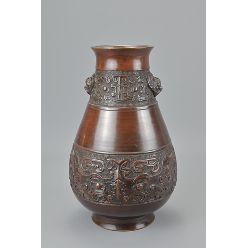 89 - A chinese bronze vase. with twin taotie mask and four character mark of wanli, height approx. 27cm