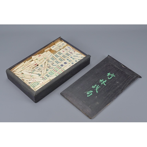 91 - A chinese majong set in fitted wooden box. width approx. 27cm