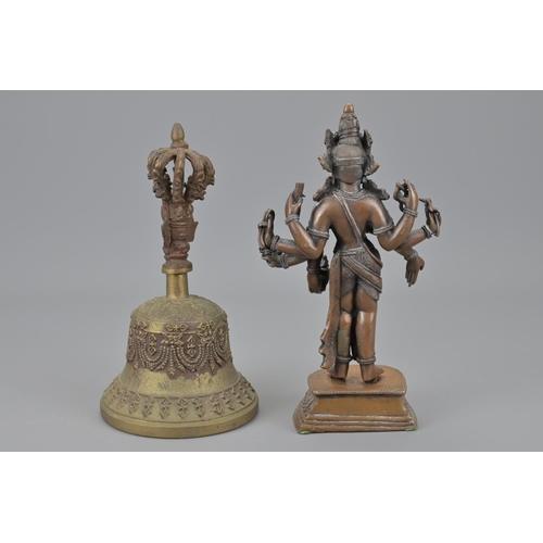 92 - An indian figure and tibetan bronze bell. figure height approx. 19cm (2)