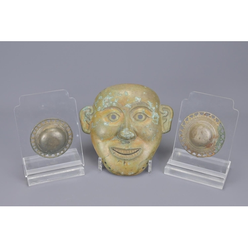 97 - A chinese bronze mask together with two bronze fittings. mask width approx. 20cm (3)