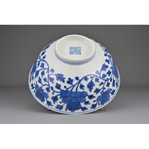 7 - A Chinese early 19th Century blue and white porcelain bowl. The exterior decorated with scrolling pe... 