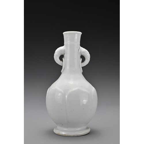 61 - A Chinese 17/18th Century white-glazed porcelain bottle vase. The rounded body decorated with raised... 