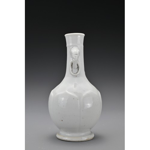 61 - A Chinese 17/18th Century white-glazed porcelain bottle vase. The rounded body decorated with raised... 