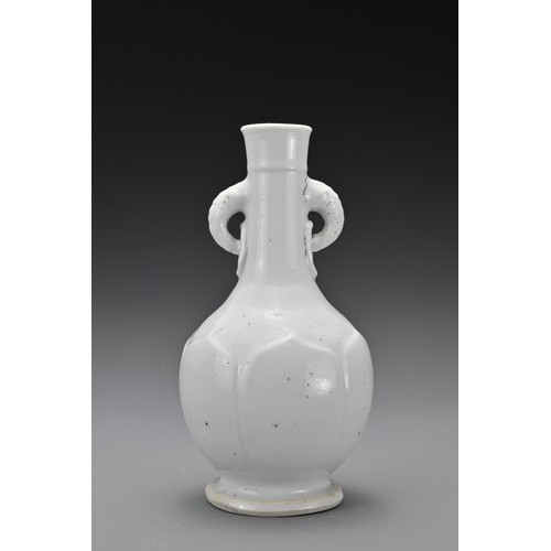 61 - A Chinese 17/18th Century white-glazed porcelain bottle vase. The rounded body decorated with raised... 