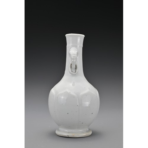 61 - A Chinese 17/18th Century white-glazed porcelain bottle vase. The rounded body decorated with raised... 