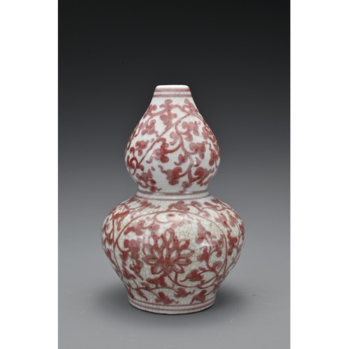 60 - A Chinese 20th Century underglaze-red vase in the form of a double gourd, decorated with floral spra... 