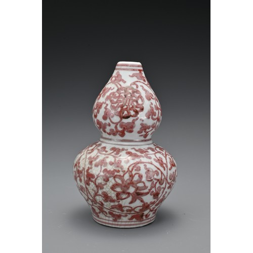 60 - A Chinese 20th Century underglaze-red vase in the form of a double gourd, decorated with floral spra... 