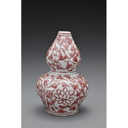 60 - A Chinese 20th Century underglaze-red vase in the form of a double gourd, decorated with floral spra... 