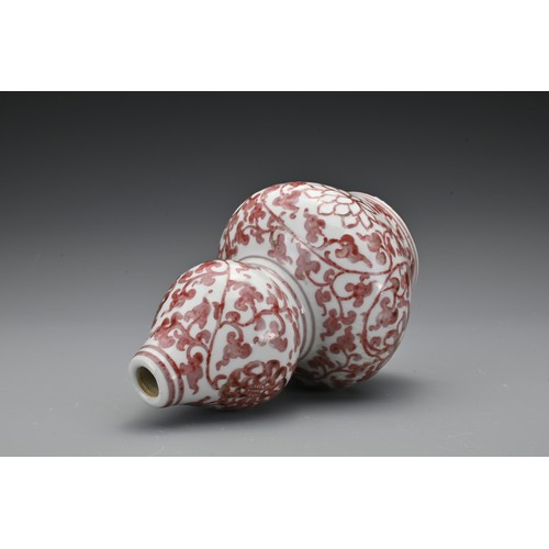 60 - A Chinese 20th Century underglaze-red vase in the form of a double gourd, decorated with floral spra... 