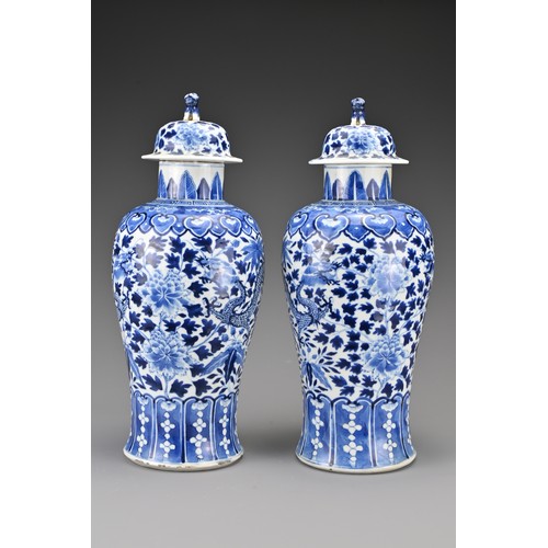 36 - A pair of Chinese 19th Century blue and white porcelain vases and covers. Decorated with four-clawed... 