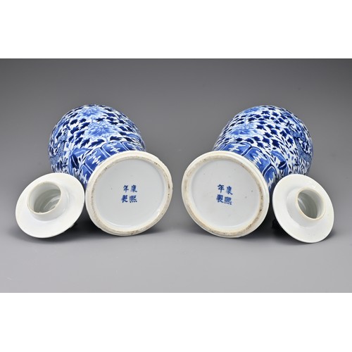 36 - A pair of Chinese 19th Century blue and white porcelain vases and covers. Decorated with four-clawed... 