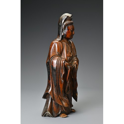 67 - A Chinese 17/18th Century carved boxwood figure of Guanyin. The figure standing with downcast eyes i... 