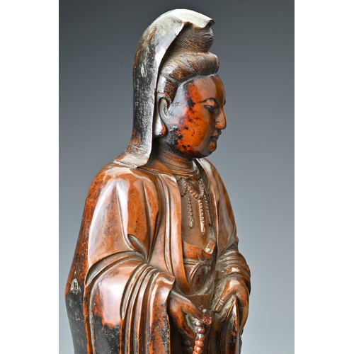 67 - A Chinese 17/18th Century carved boxwood figure of Guanyin. The figure standing with downcast eyes i... 