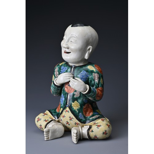 69 - A vintage Chinese polychrome ceramic figure of a boy. Height approx. 29 cm.