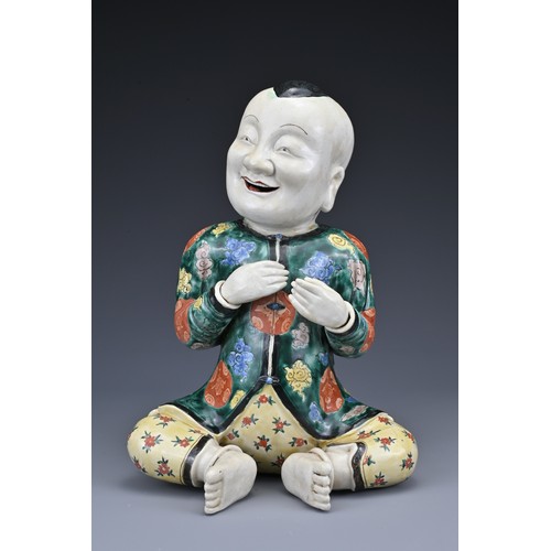 69 - A vintage Chinese polychrome ceramic figure of a boy. Height approx. 29 cm.