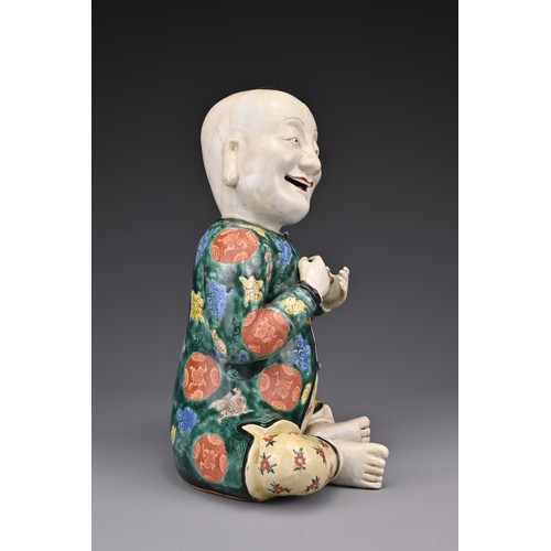 69 - A vintage Chinese polychrome ceramic figure of a boy. Height approx. 29 cm.