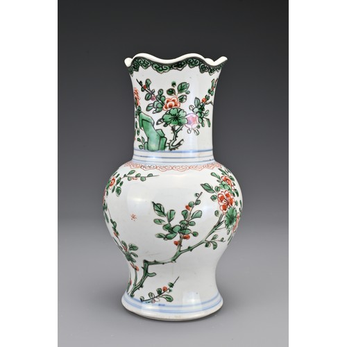 28 - A Chinese 18th Century wucai porcelain vase. The body with a lobbed rim decorated in a floral design... 