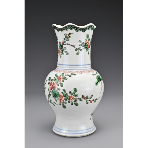 28 - A Chinese 18th Century wucai porcelain vase. The body with a lobbed rim decorated in a floral design... 