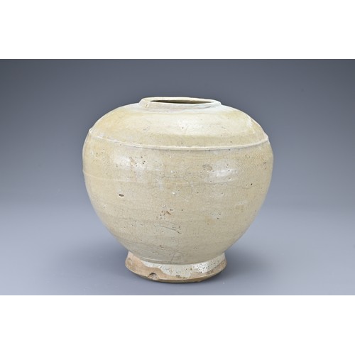 37 - A Southeast Asian stoneware ceramic jar. The globular jar on slightly splayed foot covered in a pale... 