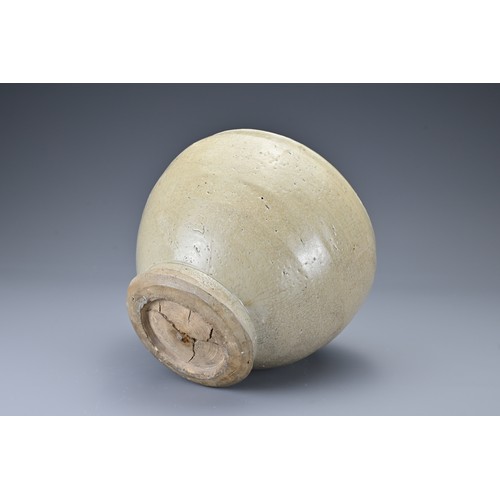 37 - A Southeast Asian stoneware ceramic jar. The globular jar on slightly splayed foot covered in a pale... 